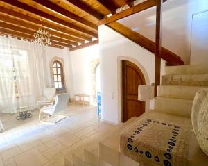 a living room with a staircase and a table at B&B Monastiriako in Giannoudi