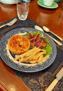 a plate of food with a sandwich and french fries at New Stone Manor in Mossel Bay