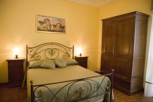 Postel nebo postele na pokoji v ubytování B&B Podere Ospedaletto