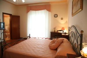 Postel nebo postele na pokoji v ubytování B&B Podere Ospedaletto