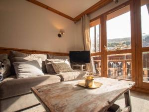 a living room with a couch and a wooden table at Appartement Valmorel, 4 pièces, 6 personnes - FR-1-291-791 in Valmorel
