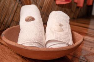 a wooden bowl filled with towels and socks at Hostal Olmito Canoa in Canoa
