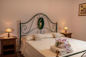 Postel nebo postele na pokoji v ubytování Agriturismo La Rocca Assisi