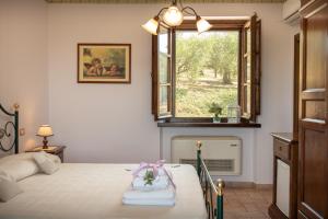 Postel nebo postele na pokoji v ubytování Agriturismo La Rocca Assisi