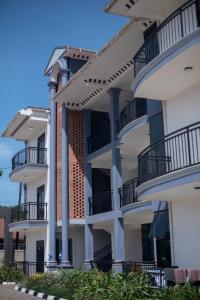 an apartment building with balconies on the side at Polo Apartments in Kampala