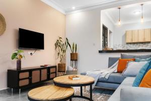 a living room with a couch and a table at Polo Apartments in Kampala