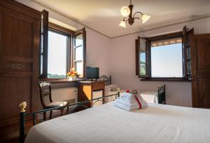 Postel nebo postele na pokoji v ubytování Agriturismo La Rocca Assisi