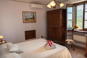 Postel nebo postele na pokoji v ubytování Agriturismo La Rocca Assisi