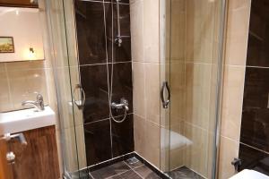 a shower with a glass door next to a sink at Sheriff Residence in Istanbul