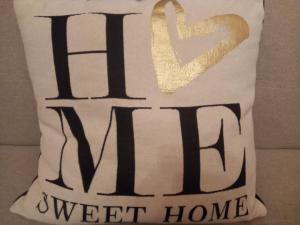 a pillow that says west home with a gold glitter heart at -- Montenapoleone City-centre Junior Suites --- all comforts - Duomo Cathedral , La Scala OperaHouse , Galleria , Sforza Castle , all by walk - subway Metro M1 San Babila Palestro M4 San Babila M3 Montenapoleone Turati in Milan