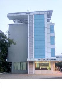 a building with a sign on the side of it at SAI SRUSHTI by NEEM SQUARE in Shirdi