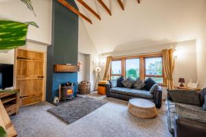a living room with a couch and a fireplace at Coorie View in Kilmore