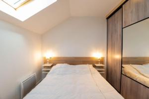 une chambre avec deux lits et une lucarne dans l'établissement Ravissante maison 3* avec jacuzzi proche lac, à Biscarrosse