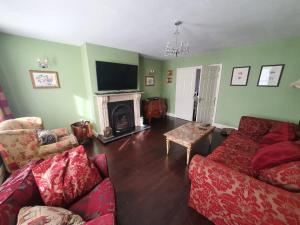 a living room with two couches and a fireplace at The Retreat in Carlingford