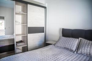 a bedroom with a bed and a glass closet at L&L Luxury Apartments in Bitola