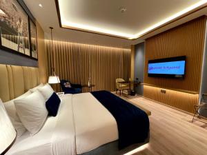 a hotel room with a bed and a flat screen tv at Planet Hollywood Thane in Thane