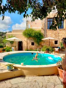 a person swimming in a pool in a house at Monastiriako in Giannoudi