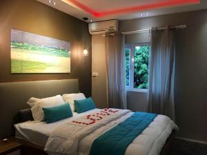 a bedroom with a large bed with a window at 2 bedrooms appartement at Flic en Flac 100 m away from the beach with shared pool furnished terrace and wifi in Flic-en-Flac