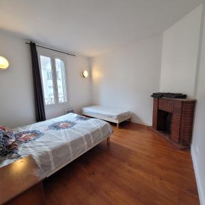 Posteľ alebo postele v izbe v ubytovaní Appart95 Saint-Brice CDG France