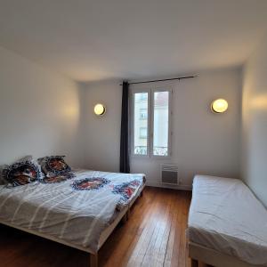 A bed or beds in a room at Hollyday Apart Paris Saint-Brice CDG France