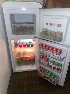 an open refrigerator filled with food and drinks at The Summit Inn in Cloudcroft