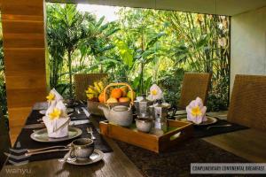 a table with a basket of fruit on top of it at Wahyu Private Peaceful Two Br Rustic Villa W Pool in Seminyak