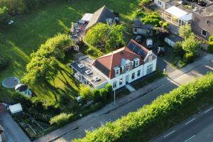 una gran casa blanca con techo rojo en Volledig gerenoveerde luxe gastsuite met ontbijt, en Vlissingen