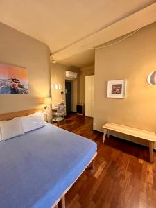 a bedroom with a large bed and a bench at MaMa in La Spezia