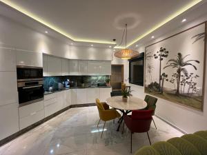 a kitchen with a table and chairs in a room at L'Emperador in Reims