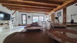 a dining room with a wooden table with glasses on it at Beau T4 au cœur du centre ville in Narbonne