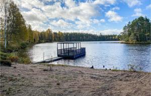 a dock in the middle of a large lake at Cozy Home In Ambjrnarp With Kitchen in Ambjörnarp