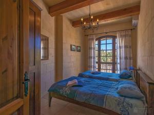 Postel nebo postele na pokoji v ubytování Razzett ta' Leli Holiday Home