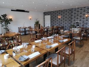 a dining room with wooden tables and chairs at Sdr. Omme Kro & Hotel in Sønder Omme