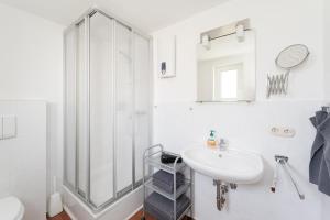 a white bathroom with a shower and a sink at Haus am Wilde Aar in Medebach +49 photos