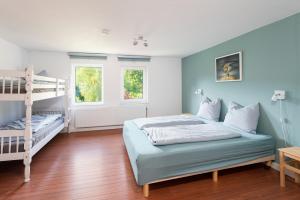 a bedroom with two bunk beds and a ladder at Haus am Wilde Aar in Medebach