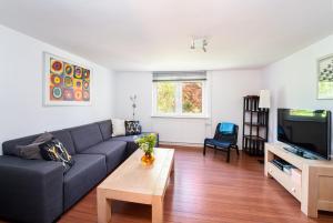 a living room with a couch and a tv at Haus am Wilde Aar in Medebach