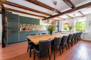 a kitchen with a long wooden table and chairs at Haus am Wilde Aar in Medebach