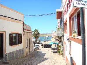 a street in a town with a view of the water at Casa de Alvor in Alvor
