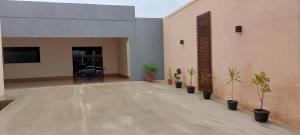 an empty courtyard with potted plants in a building at Pousada Sol do Jalapão in Ponte Alta do Tocantins