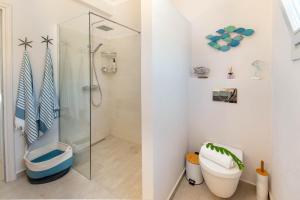 a bathroom with a shower and a toilet at Acacia APT by Aglaia V in Vlachopoulátika