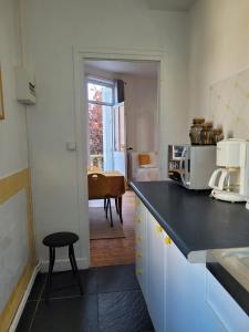 a kitchen with a counter and a table in a room at Studio19 in Clermont-Ferrand
