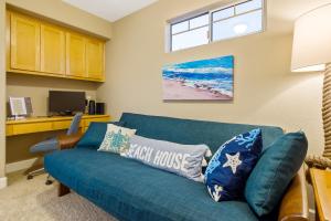 a living room with a blue couch and a window at Berry House in Arroyo Grande