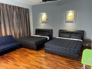 a room with two beds and a couch in it at Shamrock Villas Corner OR Seaview OR Standard in Batu Ferringhi