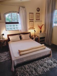 a bedroom with a large bed with a window at CasaMágica SP in Sao Paulo