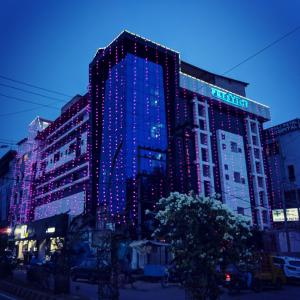 a tall building with christmas lights on it at THE PRESTIGE HOTEL & CONVENTION in Rourkela