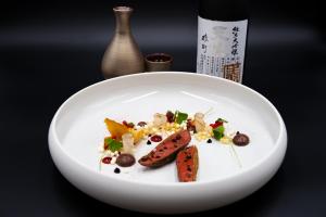 a white plate with food on a table at Hotel Jagdhaus Monzabon in Lech am Arlberg