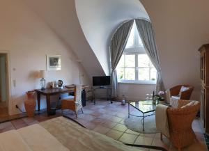 ein Wohnzimmer mit einem Tisch und einem Fenster in der Unterkunft Wein- und Landhaus S A Prüm in Bernkastel-Kues