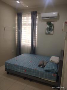 a bed sitting in a room with a window at Park Villa Homestay in Sungai Petani