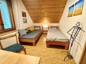 um pequeno quarto com duas camas e uma mesa em Ubytko Ivko em Letohrad