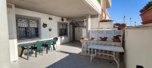 a patio with chairs and a table on a house at CasAmare in Torvaianica
